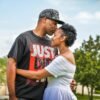 man in black crew neck t-shirt kissing woman in white dress - black love